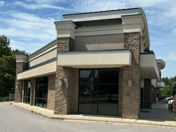 Future building of Copper Penny Small Shops Side parking lot view across from Chic-fil-A